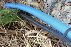 Submersible Pump Wire outdoors on rocks and grass